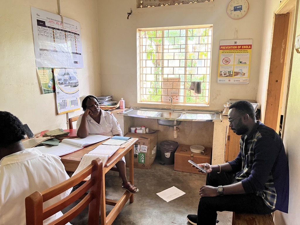 Neuravox team member reviewing records with health workers at a rural health facility in Uganda