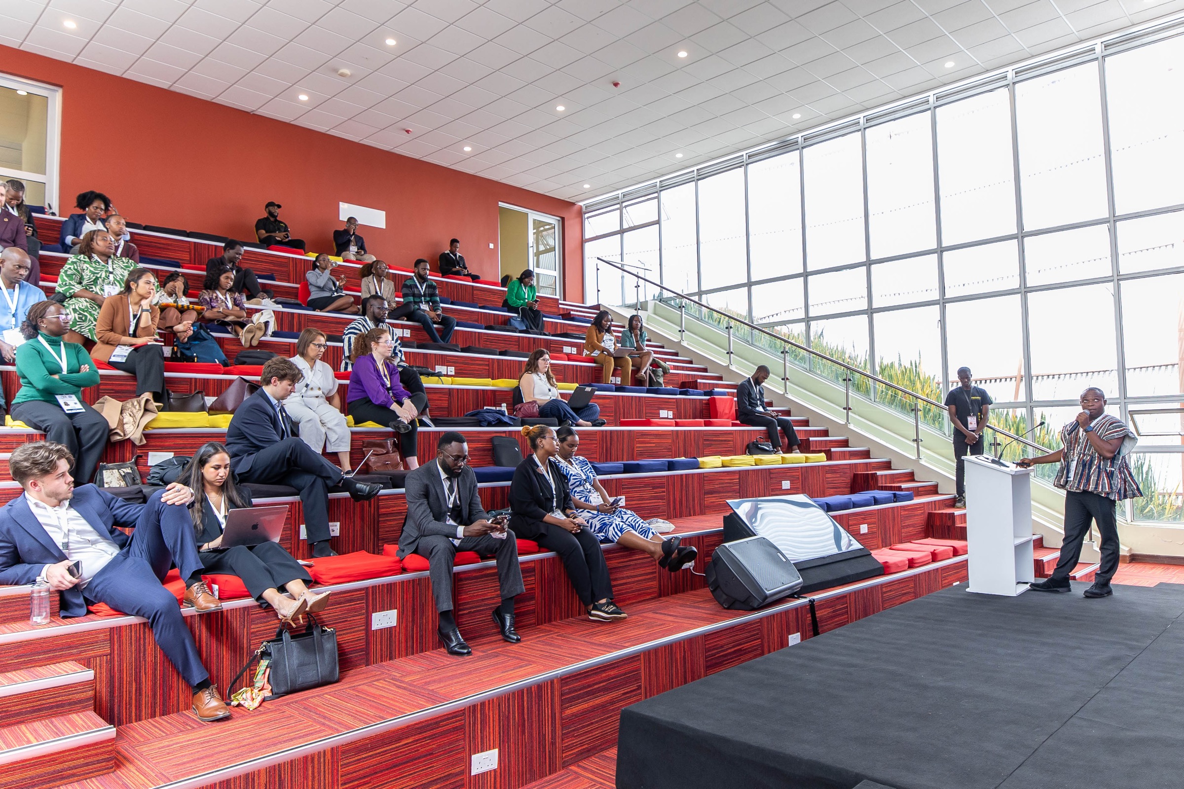 A speaker addresses participants seated in an auditorium at the Global Data Festival